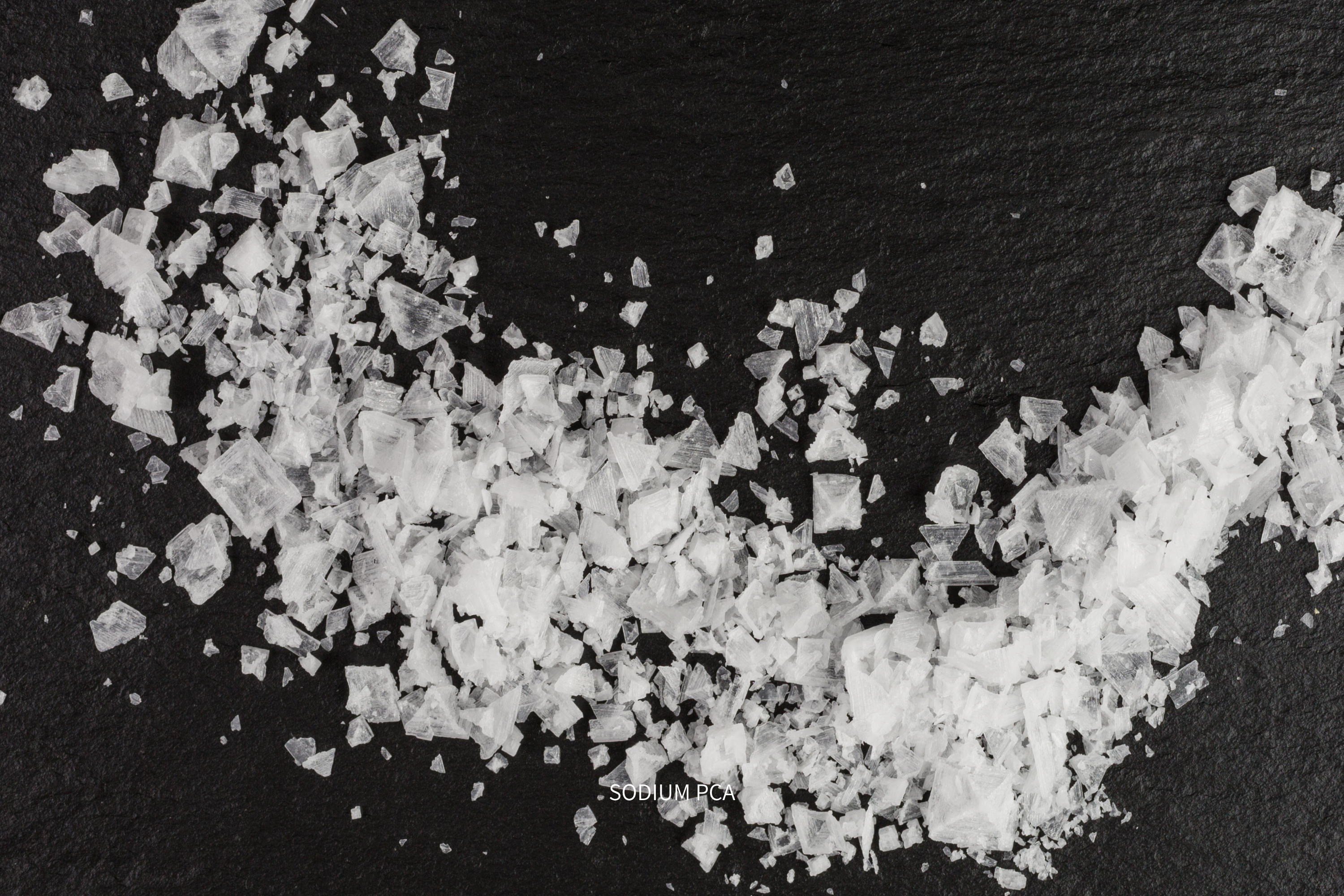 Aromanesque - Close-up of salt crystals on a black background