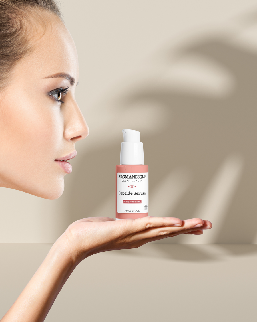 Woman holding a bottle of Bioelements Peptide Serum against a neutral background